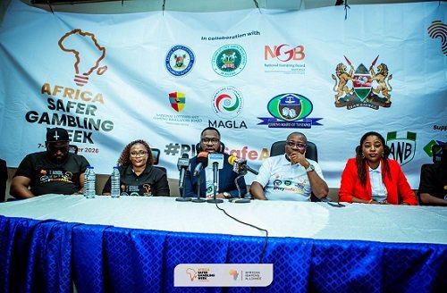 Panel of five people seated behind a blue table at a press conference during Africa Safer Gambling Week; backdrop filled with sponsor logos.
